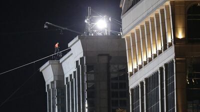 It took Mr Wallenda about six and a half minutes to walk the 138-metre stretch from the Marina City west tower to the top of a building on the other side of the river. Charles Rex Arbogast/AP Photo