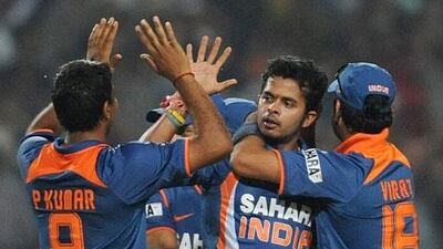 Santhakumaran Sreesanth, centre, seen in action in the 2011 World Cup final for India, was one of three cricketers to be arrested by Delhi police. Manan Vatsyayana / AFP