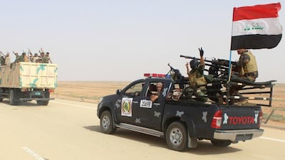 Iraqi government forces and local tribal fighters drive on the highway between the city of Ramadi and the town of Rutba as they take part in an operation to retake Rutba from ISIL on May 16, 2016. AFP / MOADH AL-DULAIMI