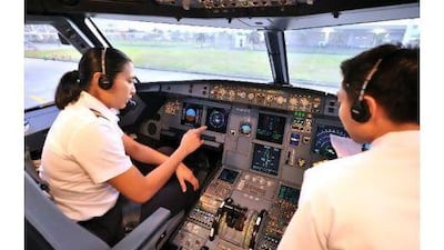 Pilot Brooke Castillo, left, gives instructions to her first officer before a flight from Iloilo international airport in the Philippines to Manila. Ms Castillo is the Philippines' first female commercial jet captain.