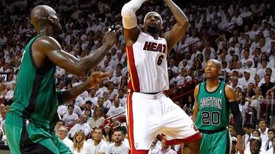 eBron James attempts a shot against Boston Celtics' Kevin Garnett and Ray Allen