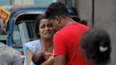A woman and her newborn baby leave their house as the military try to defuse a suspected bomb in a van before it exploded. Reuters