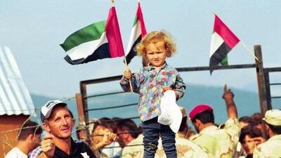 A young girl waves the UAE flag as refugees prepare to return home from Albania to Kosovo. Courtesy: Maj Gen Obaid Al Ketbi