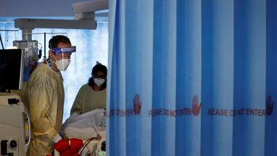 Firefighter Dan Joslin helps prone a Covid-19 patient as he works alongside critical care nurses in the Intensive Care Unit (ICU) at Queen Alexandra Hospital in Portsmouth, southern England. AFP