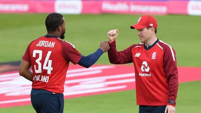 England's Chris Jordan and Eoin Morgan celebrate taking the wicket of Shoaib Malik who was out for 14. Reuters
