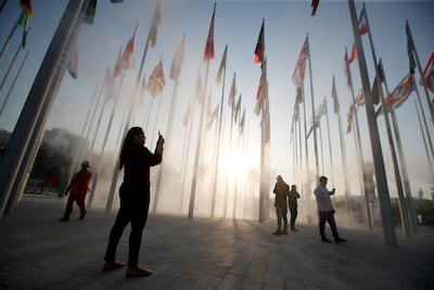 People take pictures at the new Flag Plaza on Doha corniche before the Fifa World Cup. Reuters