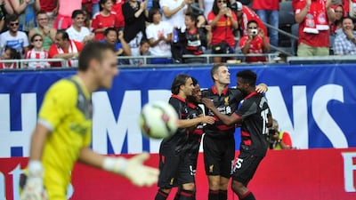 Raheem Sterling, second left, celebrates with teammates after scoring against Olympiakos on Sunday in their opening match at the International Champions Cup in the US. David Banks / Getty Images / AFP / July 27, 2014