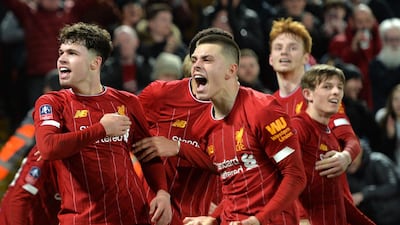 Liverpool players Adam Lewis (C) and Neco Williams (L) celebrate after going 1-0 up through an own-goal by Shrewsbury Town. EPA