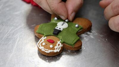 Anthony Reilly, head chef at Senara The Palm in Dubai, decorates gingerbread-man biscuits. Pawan Singh / The National