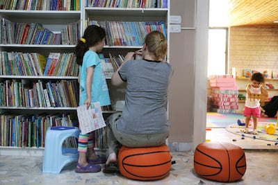 Visitors, young and old, enjoy the vast array of reading options on offer. Courtesy Salah Malkawi for The National