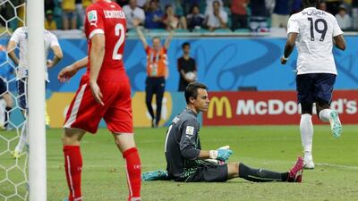 Switzerland goalkeeper Diego Benaglio reacts after Moussa Sissoko, unseen, scores France's fifth goal while Paul Pogba, right, begins celebrating and Stephan Lichtsteiner, left, looks on during the 2014 World Cup on Friday in Salvador, Brazil. David Vincent / AP