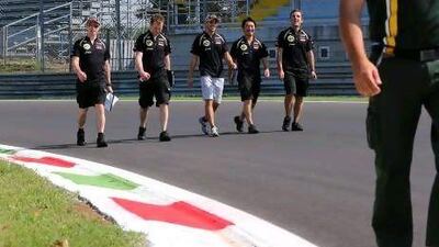 Jerome D'Ambrosio, centre, walks the Monza track with Lotus engineers.