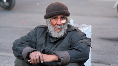 An elderly protester rests during the anti-government demonstration in downtown Baghdad, Iraq. AP Photo