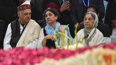 Mr Singh's widow Gursharan Kaur, right, sits by his casket at Congress party headquarters in New Delhi. AP Photo