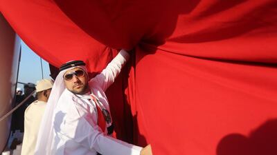A large UAE flag is launched in Ras al Khaimah as residents celebrate UAE’s National Day. Sammy Dallal / The National