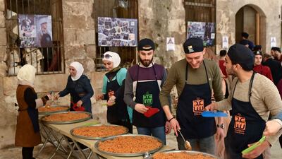 Volunteers from the charity Saaed, which means assist in Arabic, provide iftar for residents in Syria's northern city of Aleppo. AFP