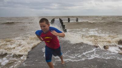 Bobby Starnes, 11, plays near a pier in Bacliff, Texas, as Hurricane Harvey approaches the Texas coast. Stuart Villanueva / The Galveston County Daily News via AP