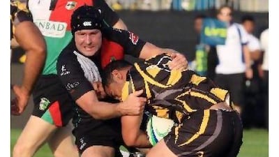 Abu Dhabi's Alastair Common, left, tackles a Dubai Wasps player at Emirates Palace.