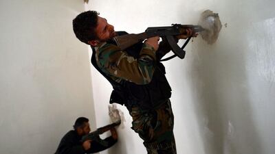 A Syrian rebel fires towards a position held by regime forces in the old northern city of Aleppo, Syria. Dimitar Dilkoff / AFP
