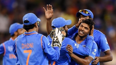 Umesh Yadav, right, is congratulated by teammates after taking the wicket of Mushfiqur Rahim. Yadav took figures of 4-31 during India's quarter-final win over Bangladesh. Andy Brownbill / AP Photo