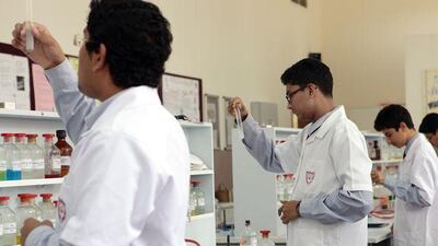 Chemistry students do lab work at the Indian High School.