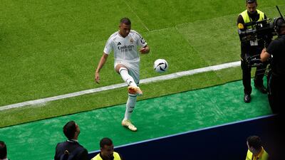 Kylian Mbappe kicks a ball into the crowd at Santiago Bernabeu Stadium. AFP