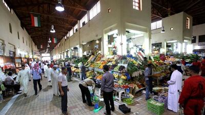 A fruits and vegetables market in downtown Kuwait City. The IMF has repeatedly urged Kuwait to reduce subsidies as spending rises. Yasser Al Zayyat / AFP