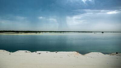 Rain clouds roll in across the mangroves along the E12 by Saadiyat Island, Abu Dhabi. Showers fell across the emirate. Victor Besa / The National.
