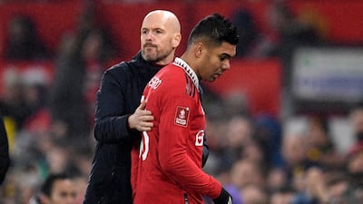 Manchester United manager Erik ten Hag with Casemiro after the midfielder is substituted during the FA Cup fourth round match against Reading. AFP