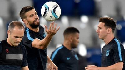 Barcelona players Andres Iniesta, left, Gerard Pique, centre, and Lionel Messi take part in training ahead of the Uefa Super Cup. Kirill Kudryavtsev / AFP