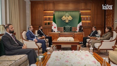 Syrian President Ahmad Al Shara, centre left, receives Mazloum Abdi, head of the SDF, centre right, in Damascus. Sana