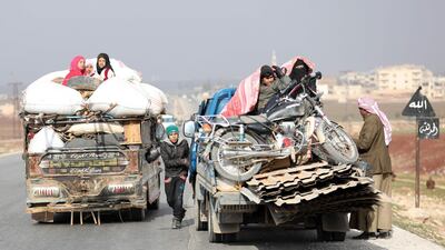 Displaced families from a village in southern Idlib head on the Damascus-Aleppo motorway towards the northern part of the rebel-held province on December 30, 2017. Omar Haj Kadour / AFP