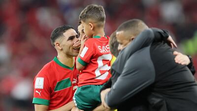 Moroccan defender Achraf Hakimi, left, with Romain Saiss and his son. AFP