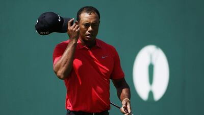 Tiger Woods tips his cap on the 18th green after finishing his final round on Sunday. Stefan Wermuth / Reuters