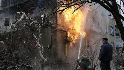A firefighter at work after a residential block on the outskirts of Donetsk caught fire following a shelling yesterday. Maxim Shemetov / Reuters
