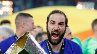 Chelsea's Gonzalo Higuain celebrates winning the Europa League with the trophy. REUTERS