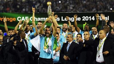 Entente Setif captain Farid Mellouli holds up the African Champions League trophy after his side's 3-3 away goals victory over DR Congo club AS Vita Club on Saturday night in Blida, Algeria. Farouk Batiche / AFP / November 1, 2014