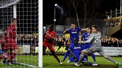 Adebayo Akinfenwa of AFC Wimbledon pokes the ball into the net to score a goal and briefly equalise in his side's eventual 2-1 FA Cup third round loss to Liverpool. Michael Regan / Getty Images