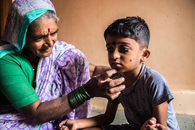 Kusum Gaikwad applies kohl to her grandson, Yash, 5. Sanket Jain for The National