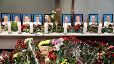 Flowers and candles are placed in front of the portraits of the flight crew members of the Ukraine International Airlines Boeing 737-800 plane that crashed in Iran, at a memorial at the Boryspil International airport outside Kiev. Reuters