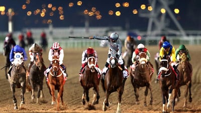 Jockey Victor Espinoza, centre, rides California Chrome to victory in the Dubai World Cup at Meydan Racecourse on March 26, 2016 in Dubai, United Arab Emirates. Warren Little/Getty Images