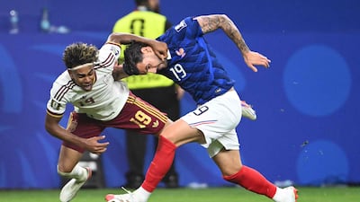 Spanish forward Lamine Yamal, left, is challenged by French defender Theo Hernandez in Arlington. AFP