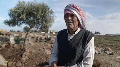 Mutarad Al Hilal Al Kouma next to the grave of his uncle, Abdo Ali, who was killed by an Israeli air strike. Matt Kynaston / The National