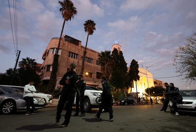 Members of the Syrian Salvation Government stand guard outside the Lady of Damascus church as Christians attend a Christmas mass on Tuesday. Reuters