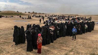 Civilians evacuated from the ISIS's embattled holdout of Baghouz wait at a screening area. AFP