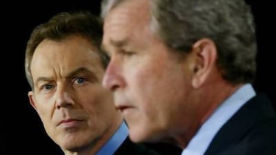 Tony Blair listens as George W Bush makes an announcement on the Iraq invasion on March 27, 2003.