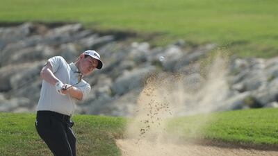 Robert Macintyre of Scotland hits a bunker shot on the 18th. Getty Images
