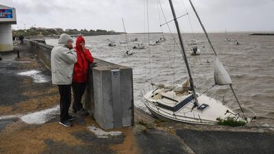 People look at stranded boats in Chatelaillon-plage, southwestern France. AFP