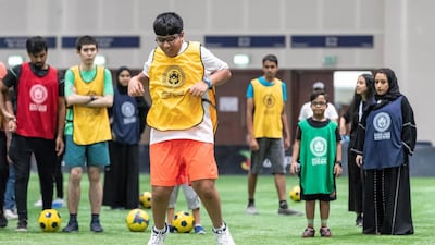 Children take part in track and field drills at Dubai Sports World.