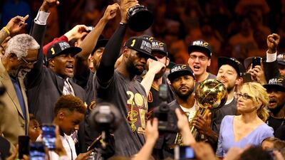 LeBron James, No 23, of the Cleveland Cavaliers holds the Bill Russell NBA Finals Most Valuable Player Award after defeating the Golden State Warriors 93-89 in Game 7 of the NBA Finals at Oakland, California. Ezra Shaw / Getty Images / AFP